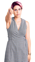 Sticker - Young beautiful woman with pink hair wearing casual clothes looking unhappy and angry showing rejection and negative with thumbs down gesture. bad expression.