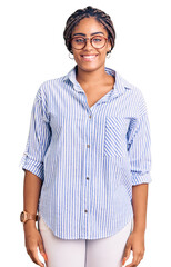 Poster - Young african american woman with braids wearing casual clothes and glasses with a happy and cool smile on face. lucky person.