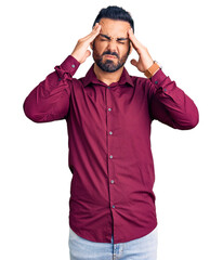 Wall Mural - Young hispanic man wearing casual clothes suffering from headache desperate and stressed because pain and migraine. hands on head.