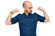© Krakenimages.com - Young hispanic man wearing casual clothes showing arms muscles smiling proud. fitness concept.