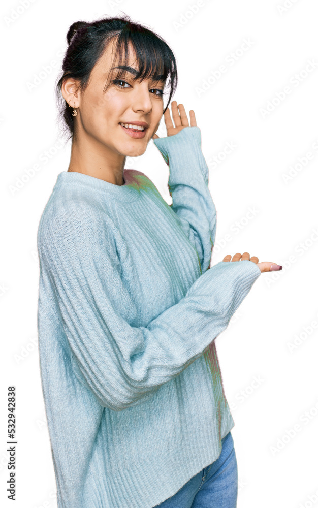 Young hispanic woman wearing casual clothes inviting to enter smiling natural with open hand
