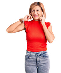 Wall Mural - Young blonde woman wearing casual clothes covering ears with fingers with annoyed expression for the noise of loud music. deaf concept.