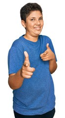 Wall Mural - Teenager hispanic boy wearing casual clothes pointing fingers to camera with happy and funny face. good energy and vibes.