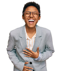 Wall Mural - Young african american woman wearing business clothes smiling and laughing hard out loud because funny crazy joke with hands on body.