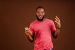 handsome african guy feeling excited about what he saw on his cellphone