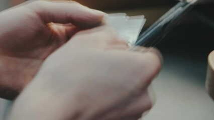 Wall Mural - Footage of goldsmith working at table in workshop. Scissors cut metal jeweler creating new jewelry. Master goldsmith working process.