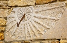 Stone Sundial With Metal Gnomon On Side Of Stone Building In The Provence, France.