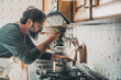 © simona - Man at home tasting food from the pot with a table spoon. People in the kitchen preparing dinner. One mature male alone cooking. Real lifestyle person testing taste and cook preparation. Husband work