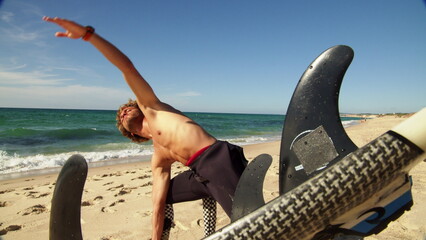 Wall Mural - Strong purposeful man doing fitness workout at the sandy beach