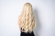© Olena Zn - Beautiful woman with long shiny blond hair on white background. Curly blond hair