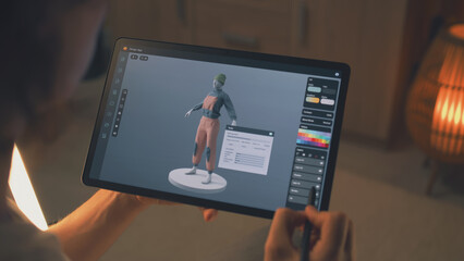 Wall Mural - male 3d designer creating design of clothes in 3d modeling application using tablet computer and dig