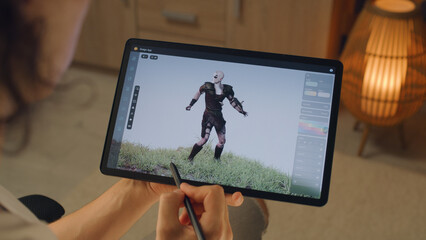 Wall Mural - male 3d designer creating 3d animation of video game character in design application on modern digit