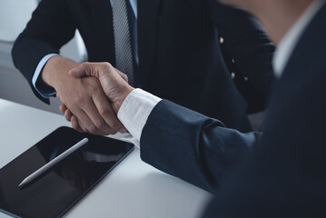 Business handshake. Two businessmen shaking hand after signing business contract at office, congratulation, investor, success, business interview, partnership, teamwork  concept