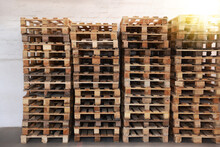 Many Empty Wooden Pallets Stacked In Warehouse