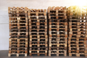 Sticker - Many empty wooden pallets stacked in warehouse