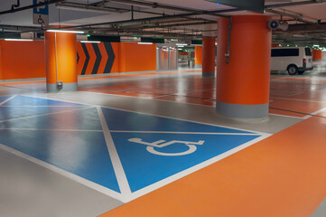 Empty car parking garage with wheelchair symbol