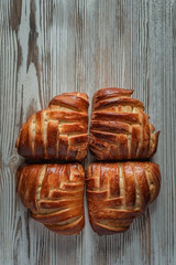 Wall Mural - Delicious homemade rich organic buns on a wooden background.