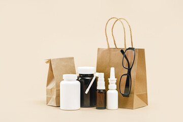 Wall Mural - pharmacy order delivery. prescription drugs and over the counter medication. Pills and spray mockup vial containers and buff paper bags. Glasses optitian. Drugstore shopping copy space