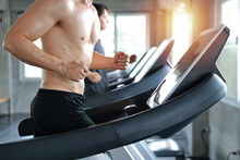 Close Up Image Of Healthy And Handsome Caucasian Muscle Man In Shirtless Who Running On Excerise Machine In Gym
