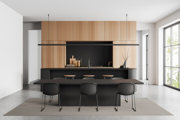 Light kitchen interior with dining area and countertop, panoramic window