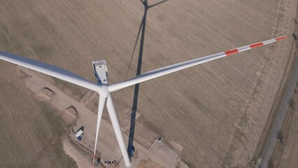 Canvas Print - Installing new wind generator, Windmill turbine maintenance, Construction site with cranes for assembling windmill tower, Wind power and renewable energy