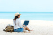 Lifestyle freelance man using laptop working and relax on the beach.  Asian people on hammock success and together your work pastime and meeting conference on internet in holiday. copy space