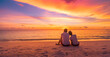 © icemanphotos - Love couple watching sunset together on beach travel summer holidays. People silhouette from behind sitting enjoying view sunset sea tropical island, destination vacation. Romantic freedom lifestyle