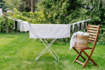 clean clothes on drying rack outdoors