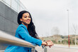 © Dani D.G - Side view of positive young African woman in casual clothes smiling and looking at camera.