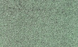 Soft rubber granular flooring surface close up green colored