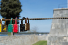 Old And Rusty Love Padlocks Locked On The Steel Cable, Symbol Of Eternal Love, In Pula, Croatia
