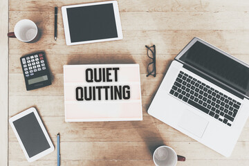 Poster - Quiet Quitting message text in vintage style light box on office deskt op