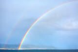 Fototapeta Tęcza - Seaside rainbow . Natural phenomenon . Rain and sunny weather