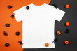 White womens cotton t-shirt halloween mockup with pumpkins and spiders on black orange background. Design t shirt template, print presentation mock up. Top view flat lay.