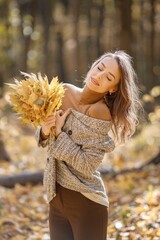 Wall Mural - Portrait of a young woman in autumn forest