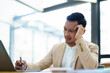 © Jirapong - Portrait of sme business owner, man using computer and financial statements Anxious expression on expanding the market to increase the ability to invest in business