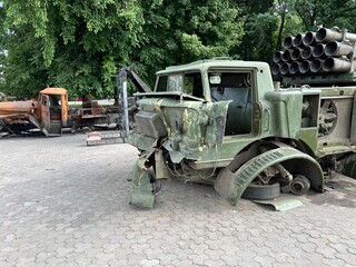 Destroyed and burned out Russian military vehicles that transported artillery installations and shells to them. Destroyed Russian military equipment stands on the street in the city. Russian artillery