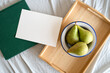 green pears in a bowl, breakfast on a tray, invitation card with space for text, picture taken from above