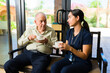© AntonioDiaz - Old man in his 80s talking with a beautiful nurse at the nursing home