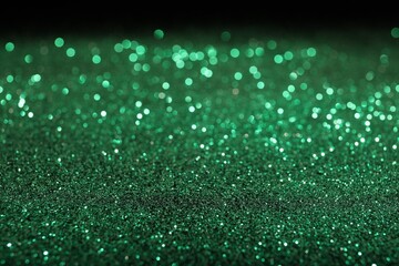 Wall Mural - shiny green glitter on black background. bokeh effect
