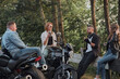 © perfectlab - A company of friends travel together on motorcycles, stopped at the roadside, have fun and drink tea
