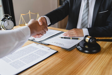 Lawyers shake hands with business people to seal a deal with partner lawyers. or a lawyer discussing contract agreements, handshake concepts, agreements, agreements