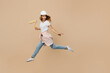© ViDi Studio - Full size young employee laborer handyman woman in white t-shirt helmet jump hold paint roller point aside isolated on plain beige background Instrument accessories renovation room Repair home concept