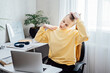 Workout at work. Office Exercises at desk, Desk Friendly Workplace Exercises To Keep Healthy at Office. Young woman office worker at her workplace stretching hands and body taking break from work