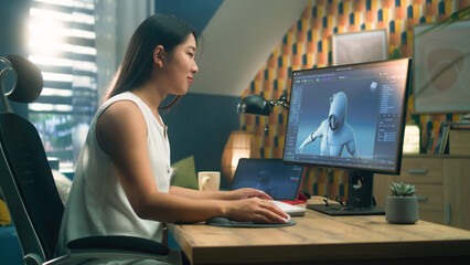 Wall Mural - asian woman creating 3d model of video game character in professional program using computer and dig