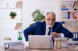 © Elnur - Old male employee in time management concept