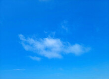 Single Wispy Cloud In A Bright Blue Sky