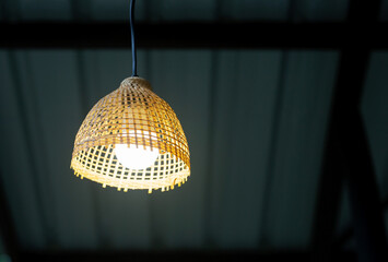 Wall Mural - The electric lamp is made from bamboo weave in yellow with a metal cheese roof background.