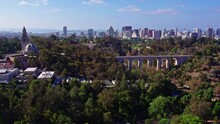 Aerial View Of Balboa Park Suburb Area In San Diego California, Urban Bridge Streets Roads And Buildings On Top Of Green Hill Park, Plane Landing And Downtown Cityscape With Coronado Bridge In Horizon