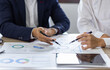 © David - Two Business working at office with documents on desk, meeting to planning analyzing the financial report, business plan investment, finance analysis concept